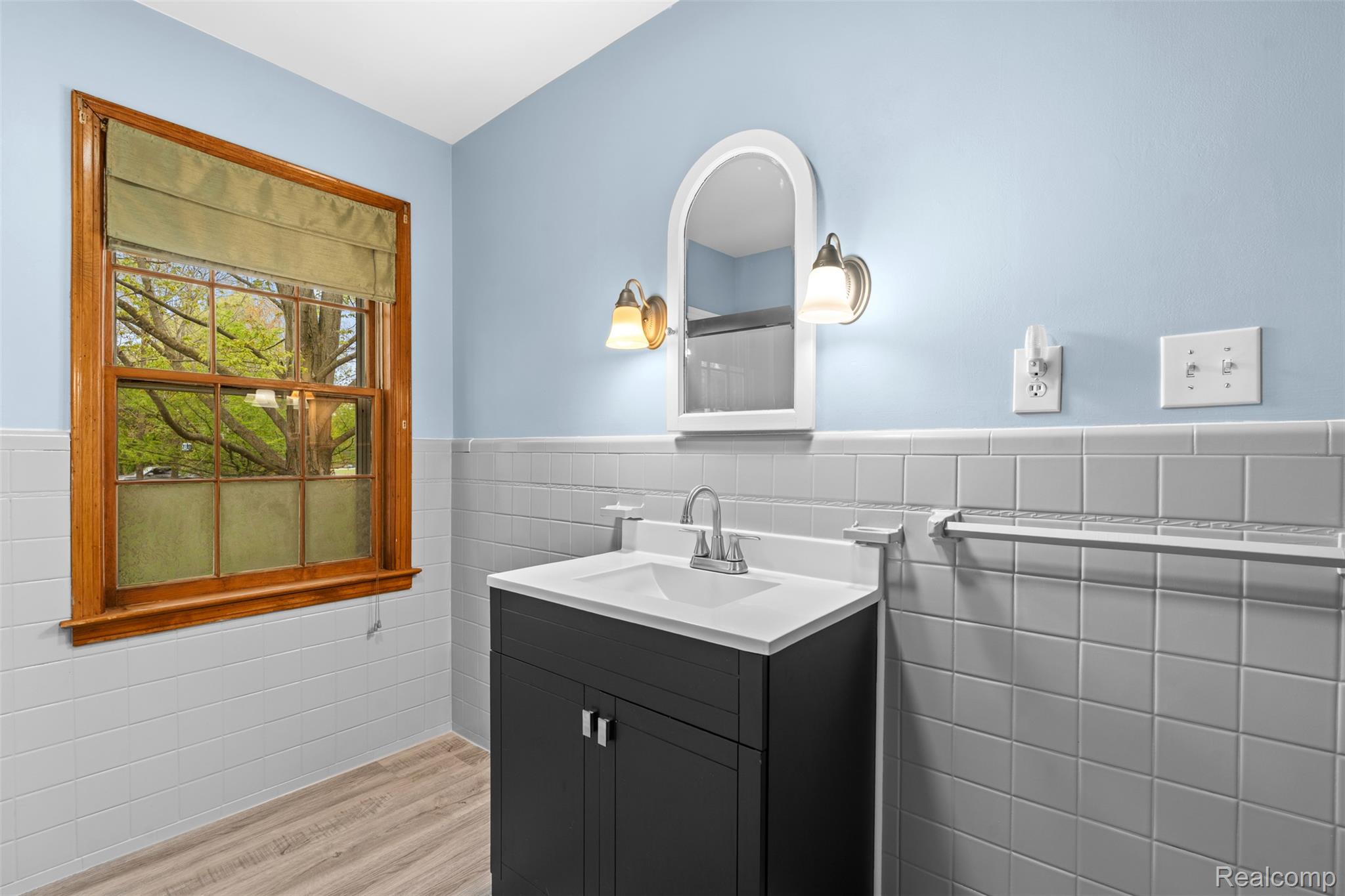 1775 Imlay City Road Lapeer, MI 48446 - Photo 20 of 60 Bathroom featuring vanity, a wainscoted wall, tile walls, and light wood-type flooring