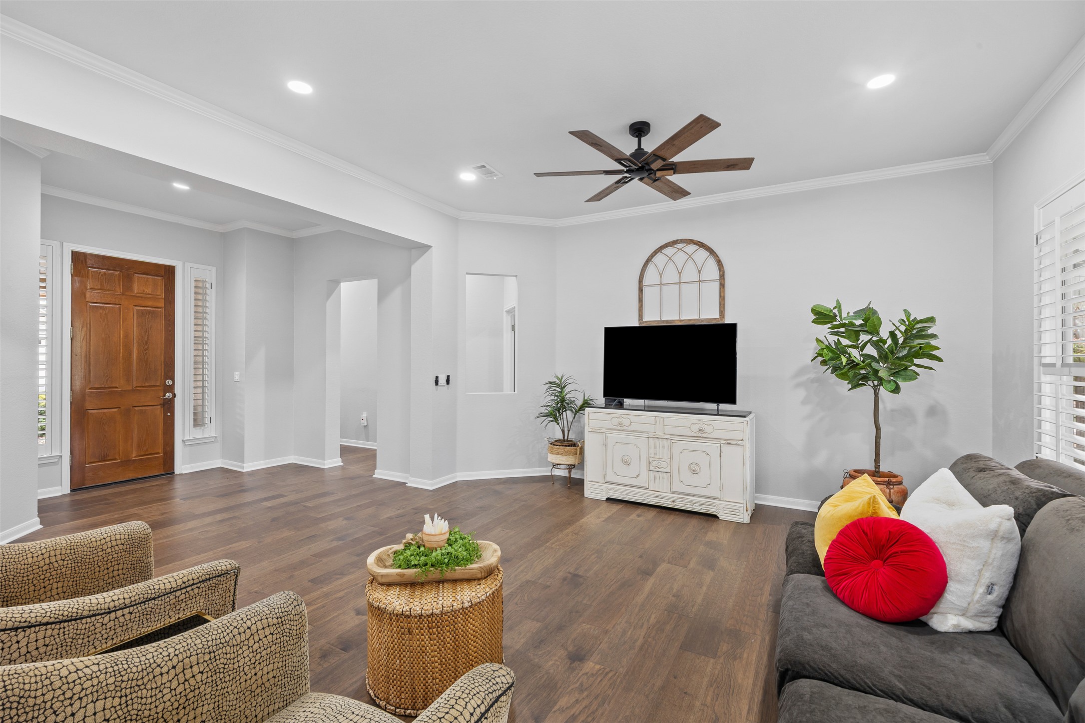 144 Stetson Trail Georgetown, TX 78633 - Photo 7 of 39 Entry opens to living room featuring dark wood finished floors, ornamental molding, and recessed lighting