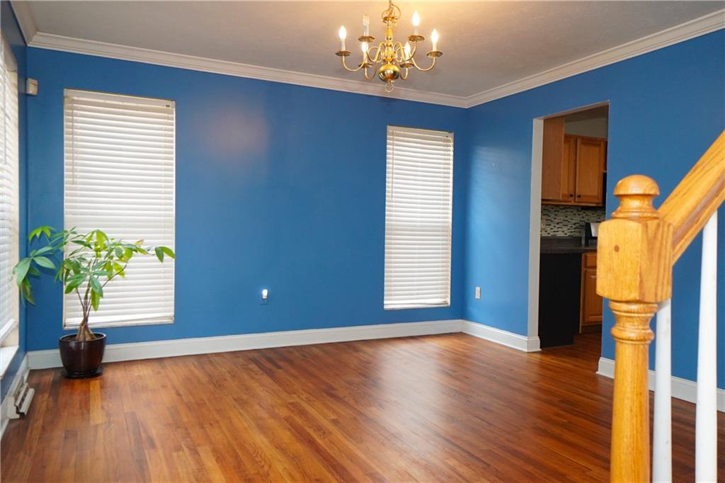 728 Mercer Street Pittsburgh, PA 15219 - Photo 5 of 27 a view of an empty room with a window and wooden floor