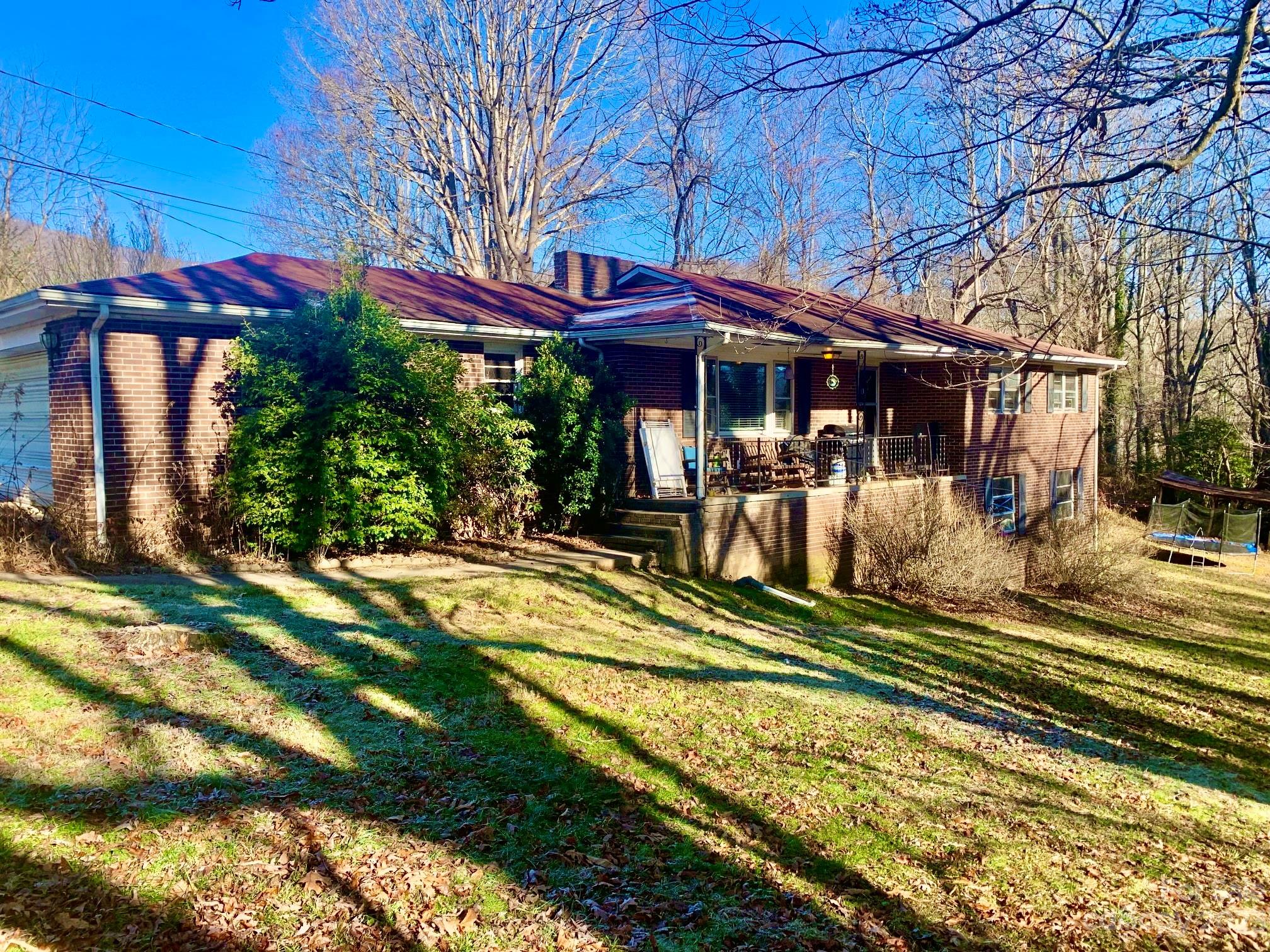 235 Log Cabin Road Waynesville, NC 28786 - Photo 1 of 23 a view of a house with backyard porch and sitting area