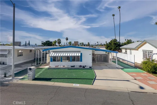 a view of a house with a yard and potted plants
