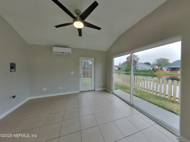 a view of a livingroom with a ceiling fan and window