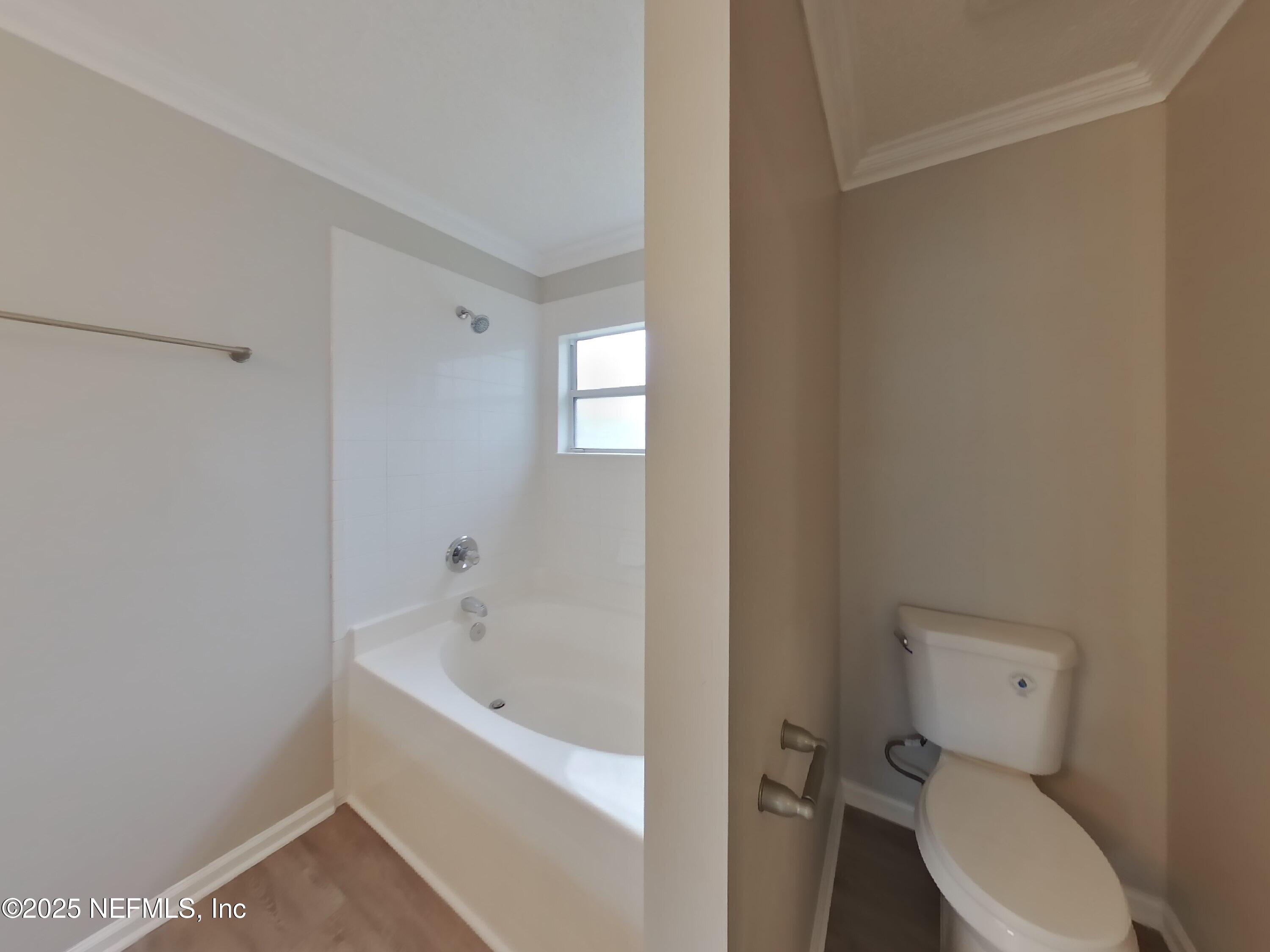 1695 Northglen Circle Middleburg, FL 32068 - Photo 7 of 14 a white toilet sitting next to a bathtub