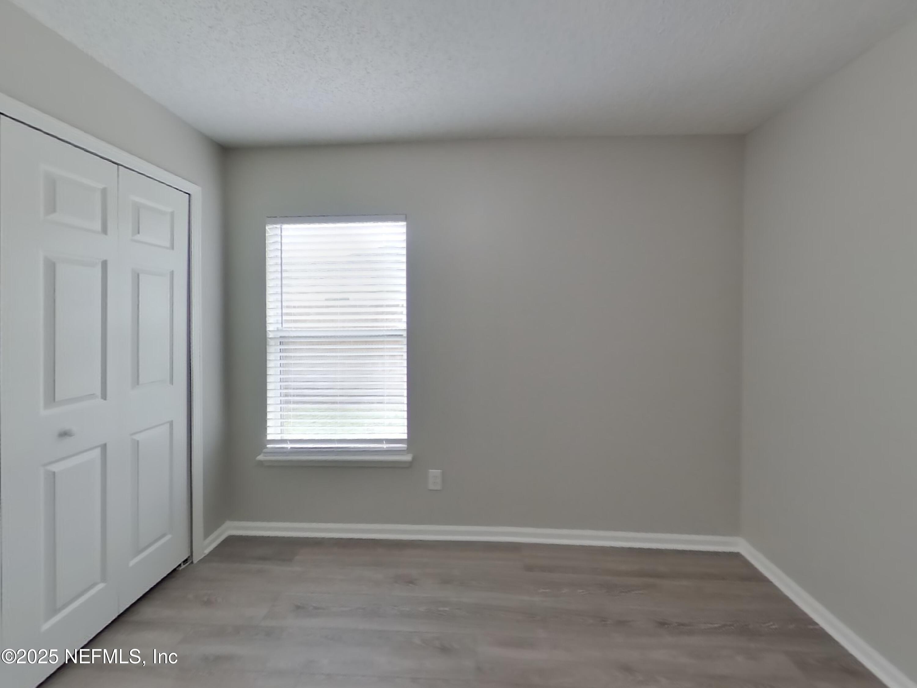 1695 Northglen Circle Middleburg, FL 32068 - Photo 9 of 14 an empty room with wooden floor and windows