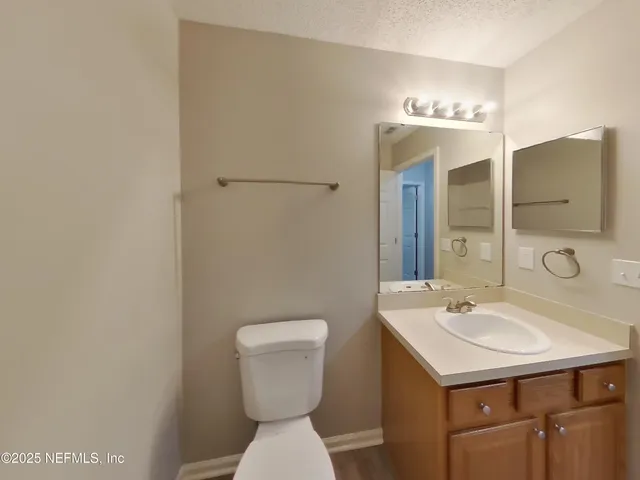 a bathroom with a sink toilet and mirror