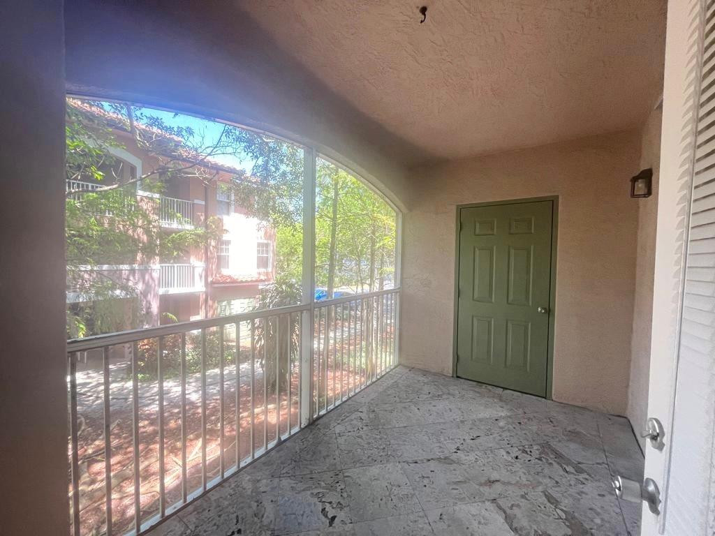 6812 West Sample Road, Unit 6812 Coral Springs, FL 33067 - Photo 13 of 27 a view of an empty room with wooden floor and a window