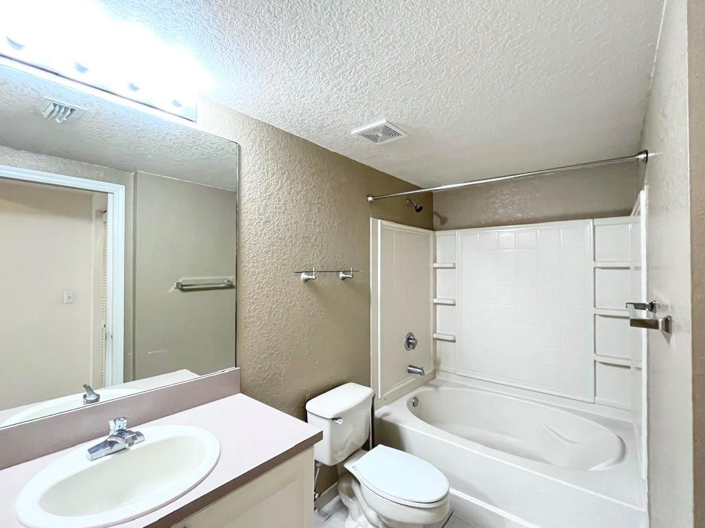6812 West Sample Road, Unit 6812 Coral Springs, FL 33067 - Photo 15 of 27 a bathroom with a sink toilet tub and shower