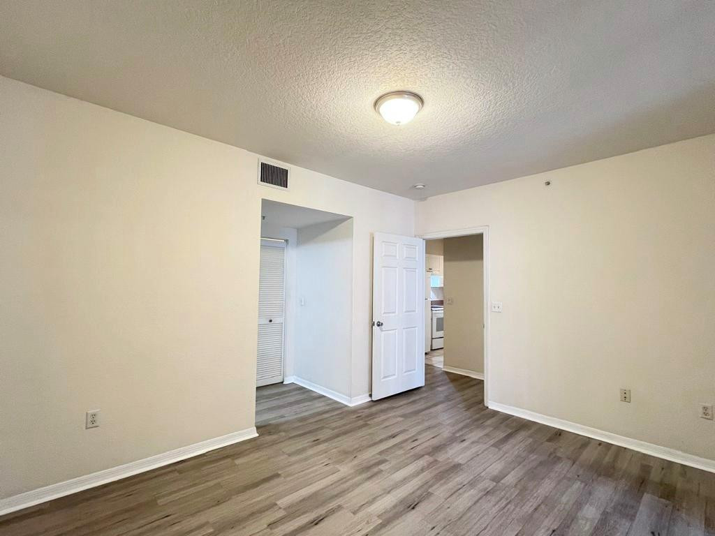 6812 West Sample Road, Unit 6812 Coral Springs, FL 33067 - Photo 17 of 27 a view of an empty room with wooden floor