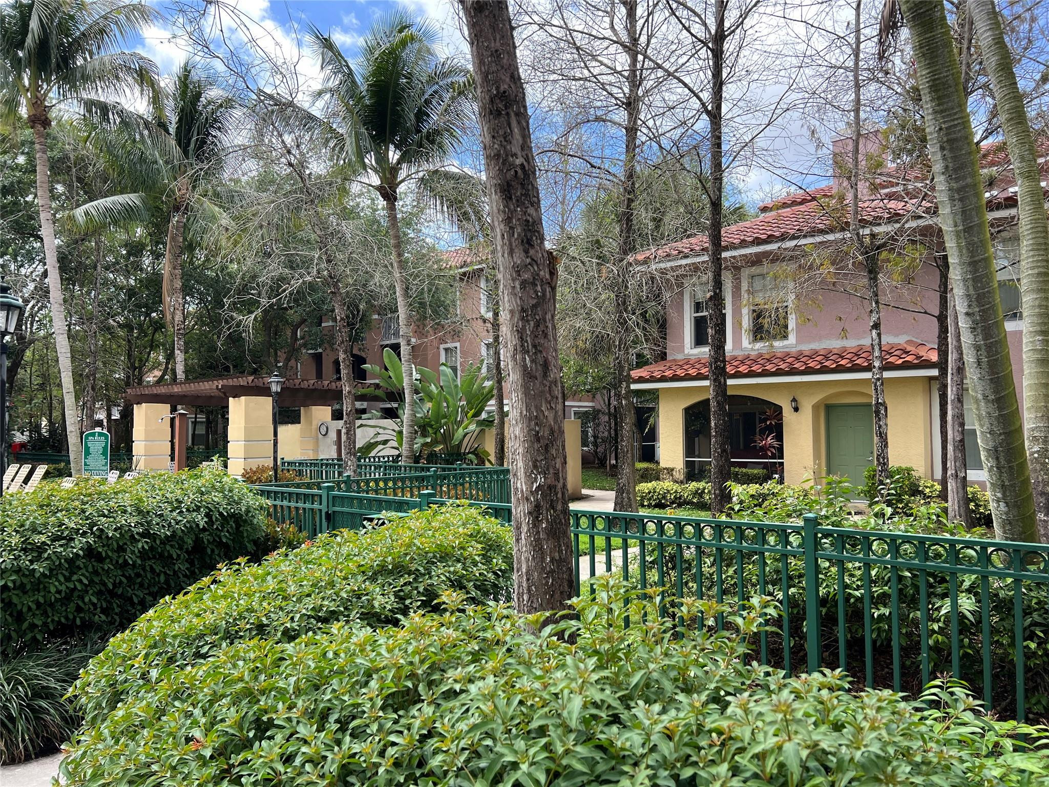 6812 West Sample Road, Unit 6812 Coral Springs, FL 33067 - Photo 22 of 27 a front view of a house with a garden