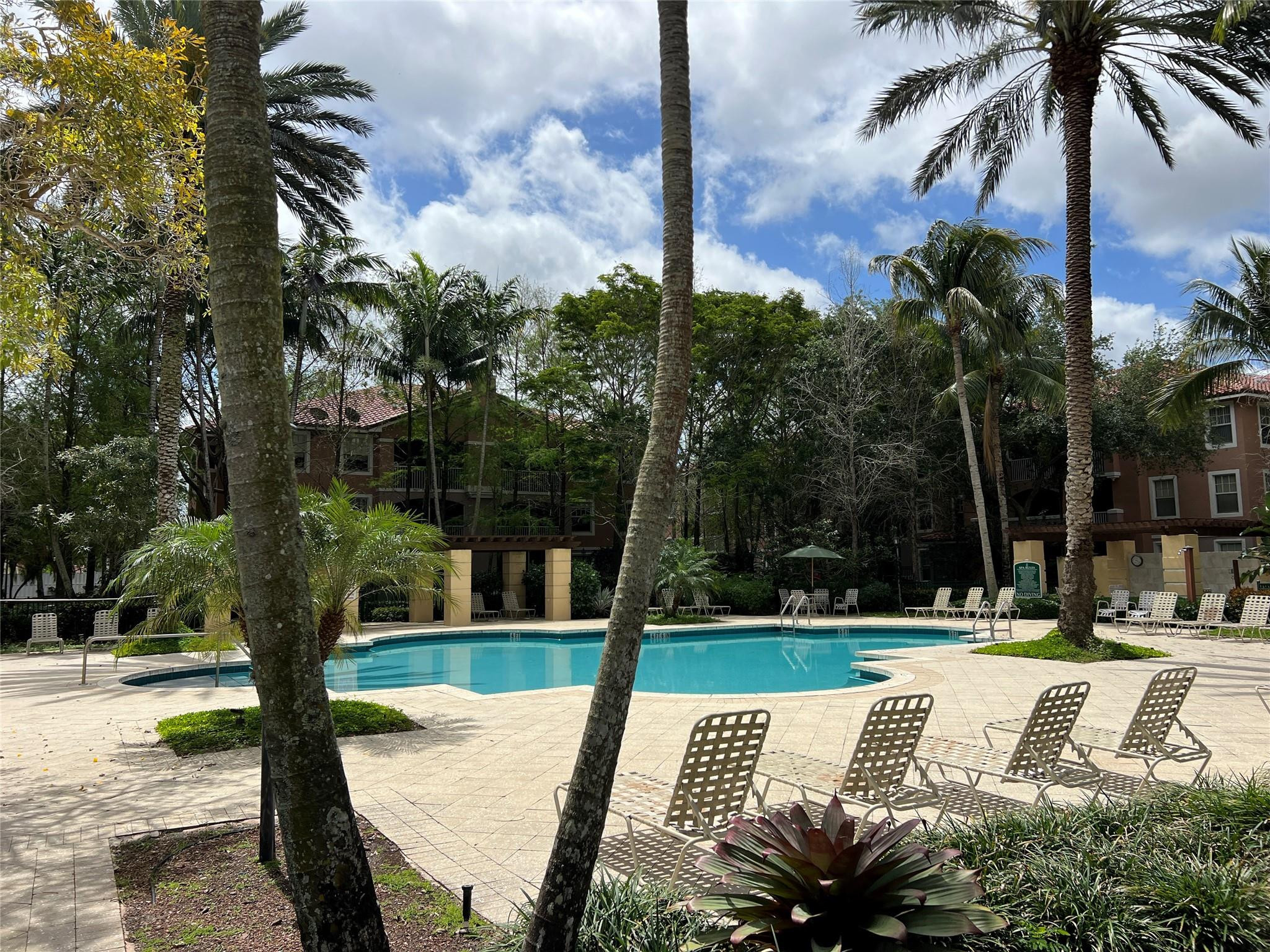 6812 West Sample Road, Unit 6812 Coral Springs, FL 33067 - Photo 24 of 27 a view of a park with swings and slides