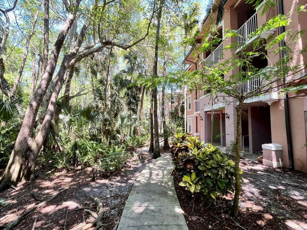 6812 West Sample Road, Unit 6812 Coral Springs, FL 33067 - Photo 3 of 27 a front view of a house with a yard