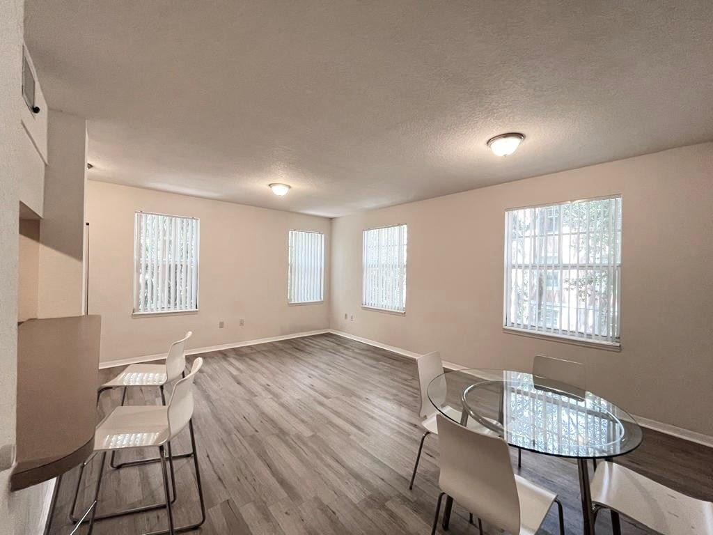 6812 West Sample Road, Unit 6812 Coral Springs, FL 33067 - Photo 7 of 27 a workspace with wooden floor and a window