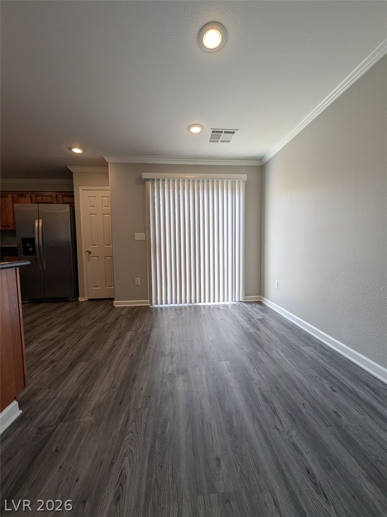 10308 Faustine Avenue Las Vegas, NV 89129 - Photo 5 of 28 Natural light illuminates plank flooring and crown molding, enhancing this airy interior space.