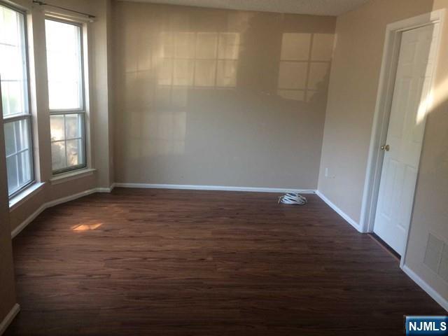 808 Sassafras Court, Unit 808 Mahwah, NJ 07430 - Photo 2 of 4 wooden floor in an empty room with a window