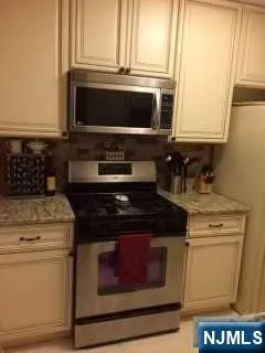 a stove top oven sitting inside of a kitchen