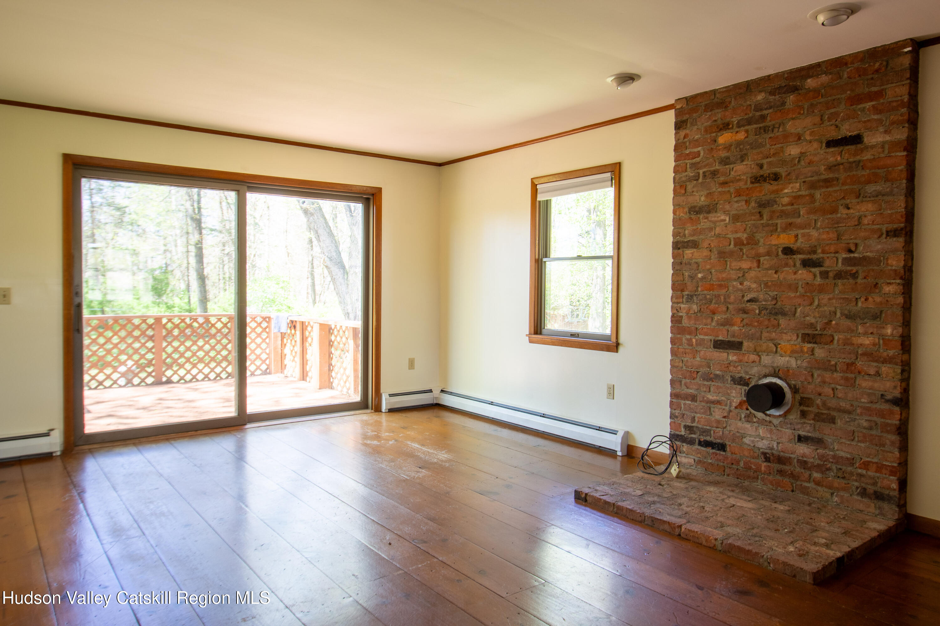 205 Fordham Road Valatie, NY 12184 - Photo 14 of 18 a view of an empty room with a window and wooden floor
