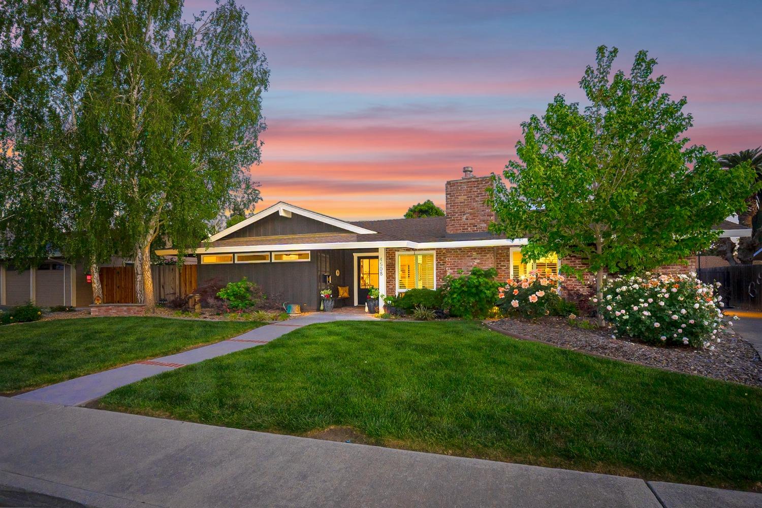 a front view of a house with a garden