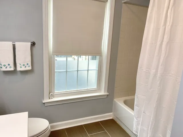 a view of a house with a yard and tree s