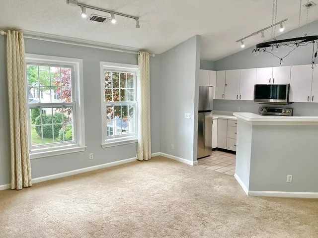 a view of work kitchen with a sink cabinets and a window