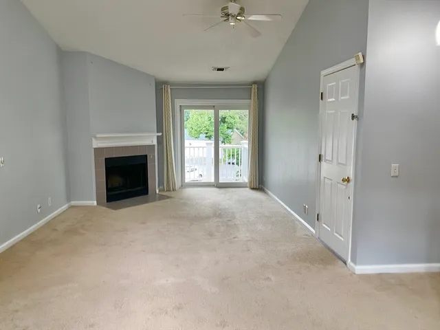 a view of empty room with a fireplace