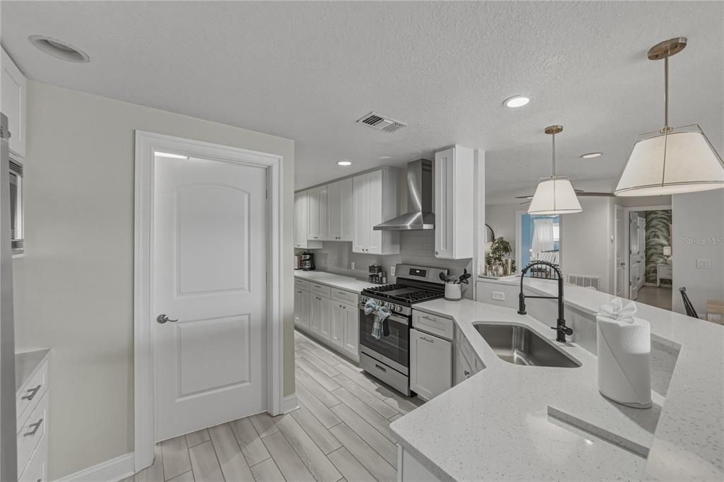 1004 Sago Palm Way Apollo Beach, FL 33572 - Photo 14 of 92 a kitchen with stainless steel appliances granite countertop a sink a stove and a refrigerator