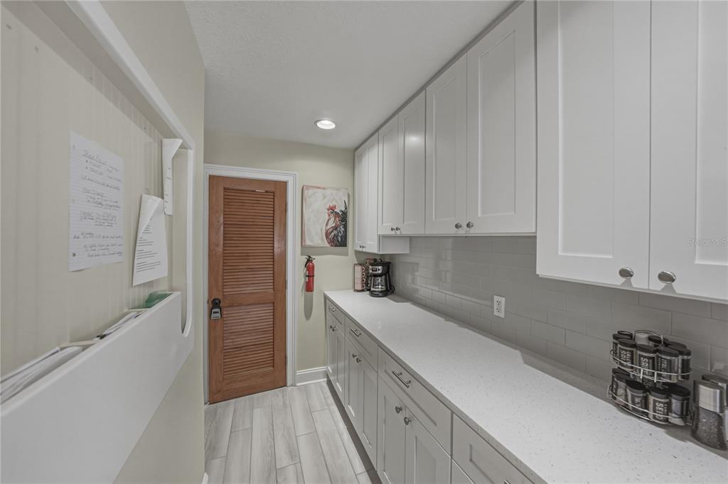 1004 Sago Palm Way Apollo Beach, FL 33572 - Photo 16 of 92 a kitchen with granite countertop a sink and cabinets