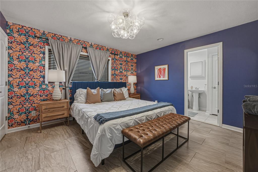 1004 Sago Palm Way Apollo Beach, FL 33572 - Photo 22 of 92 a bedroom with a bed and a chandelier