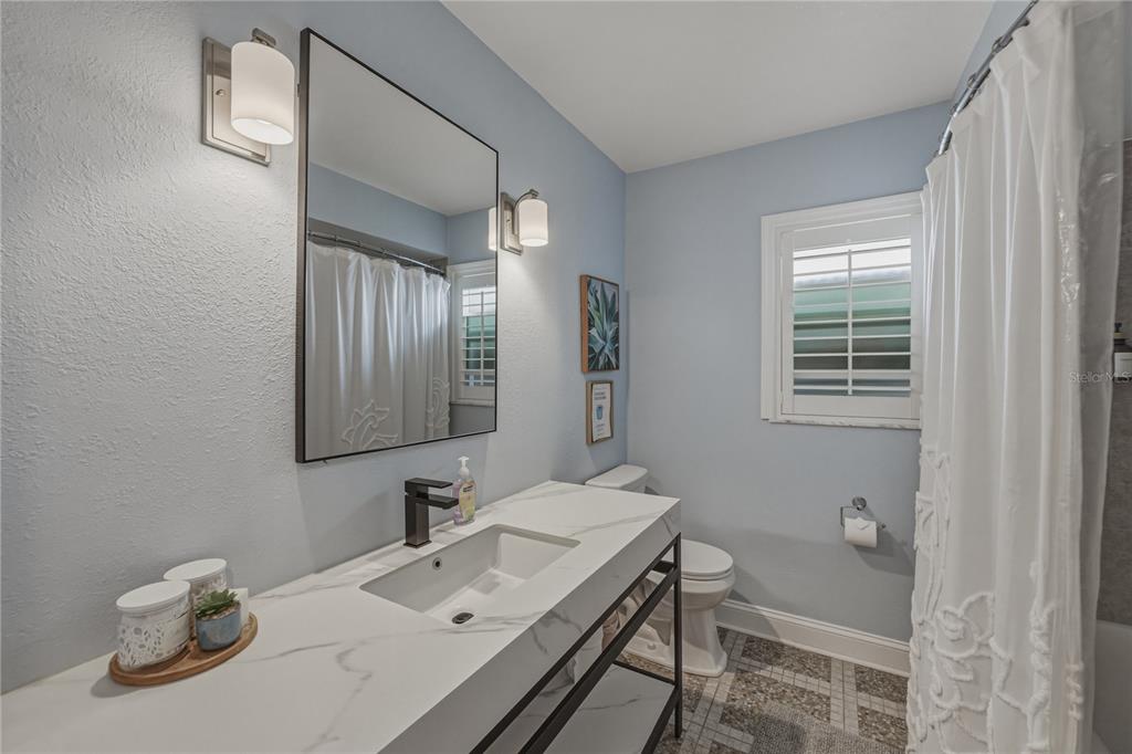 1004 Sago Palm Way Apollo Beach, FL 33572 - Photo 26 of 92 a bathroom with a sink toilet and mirror