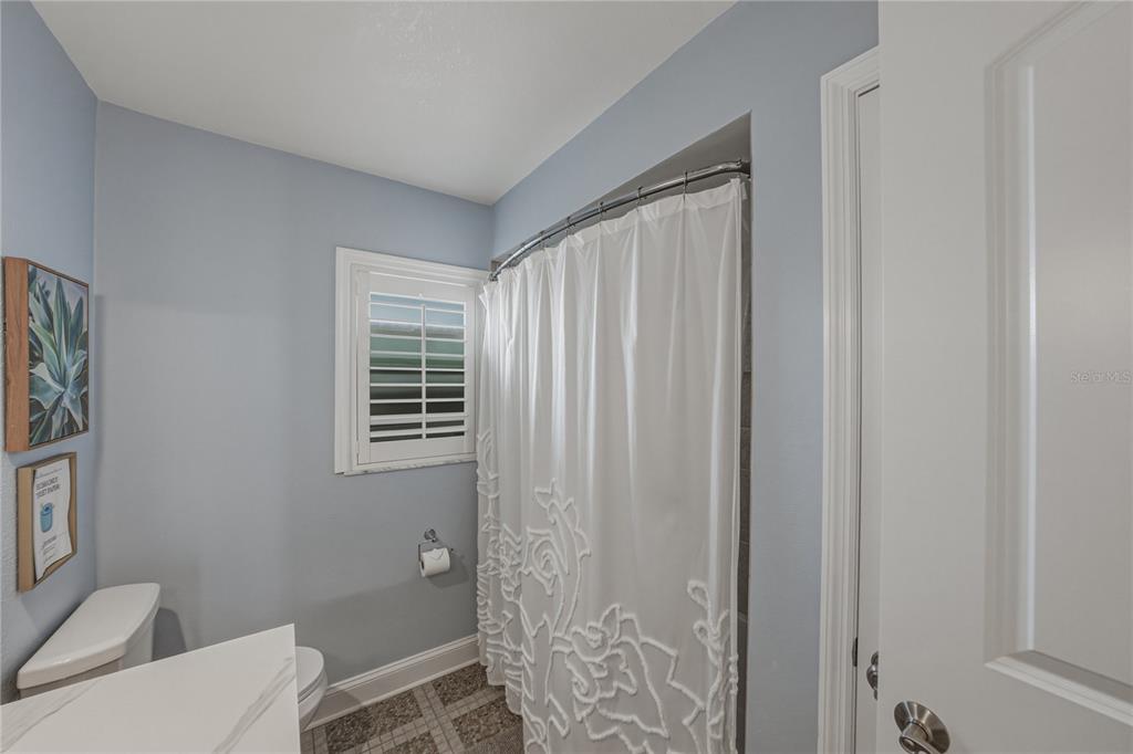 1004 Sago Palm Way Apollo Beach, FL 33572 - Photo 28 of 92 a bathroom with a toilet a sink and shower