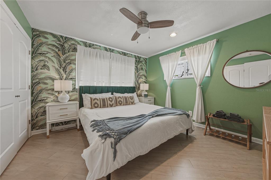 1004 Sago Palm Way Apollo Beach, FL 33572 - Photo 31 of 92 a bedroom with a bed and a chandelier