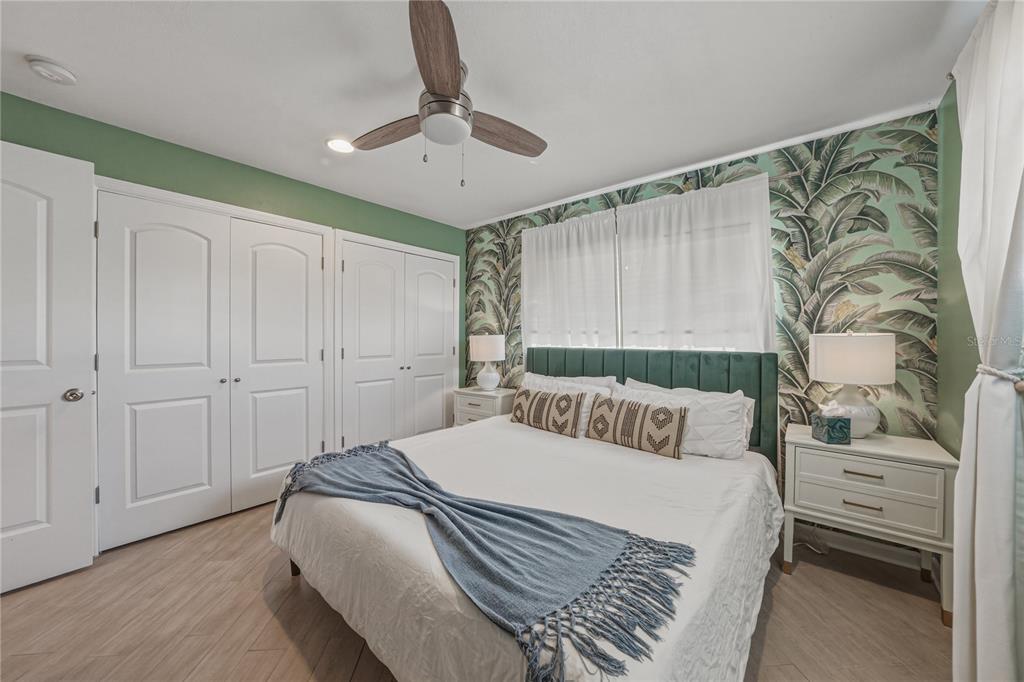 1004 Sago Palm Way Apollo Beach, FL 33572 - Photo 33 of 92 a bedroom with a large bed and a chandelier