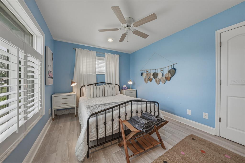 1004 Sago Palm Way Apollo Beach, FL 33572 - Photo 40 of 92 a view of a bedroom with furniture window and wooden floor