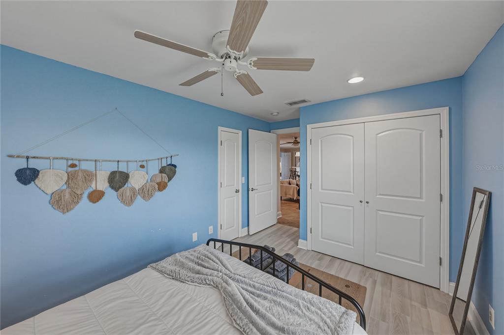 1004 Sago Palm Way Apollo Beach, FL 33572 - Photo 42 of 92 a bedroom with a large bed and a chandelier