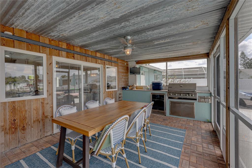 1004 Sago Palm Way Apollo Beach, FL 33572 - Photo 46 of 92 a dining room with furniture a floor to ceiling window and wooden floor
