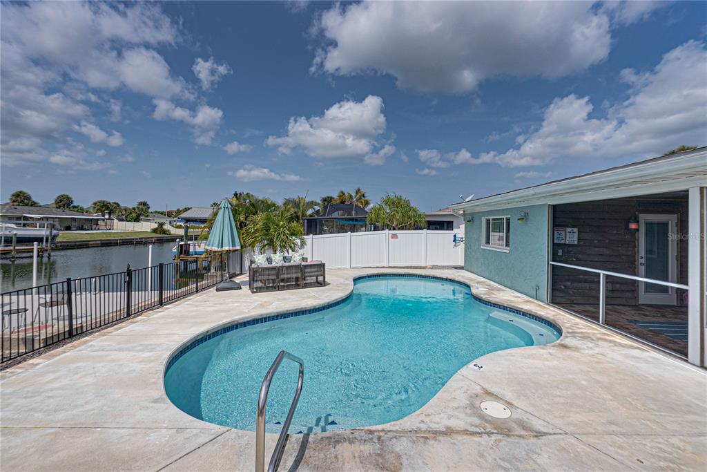 1004 Sago Palm Way Apollo Beach, FL 33572 - Photo 62 of 92 a swimming pool with outdoor seating and barbeque oven