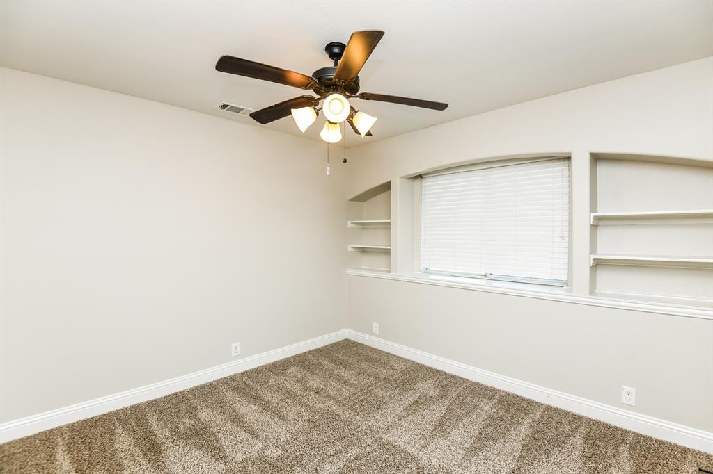 826 Graham Drive Burleson, TX 76028 - Photo 13 of 18 an empty room with a window and a ceiling fan