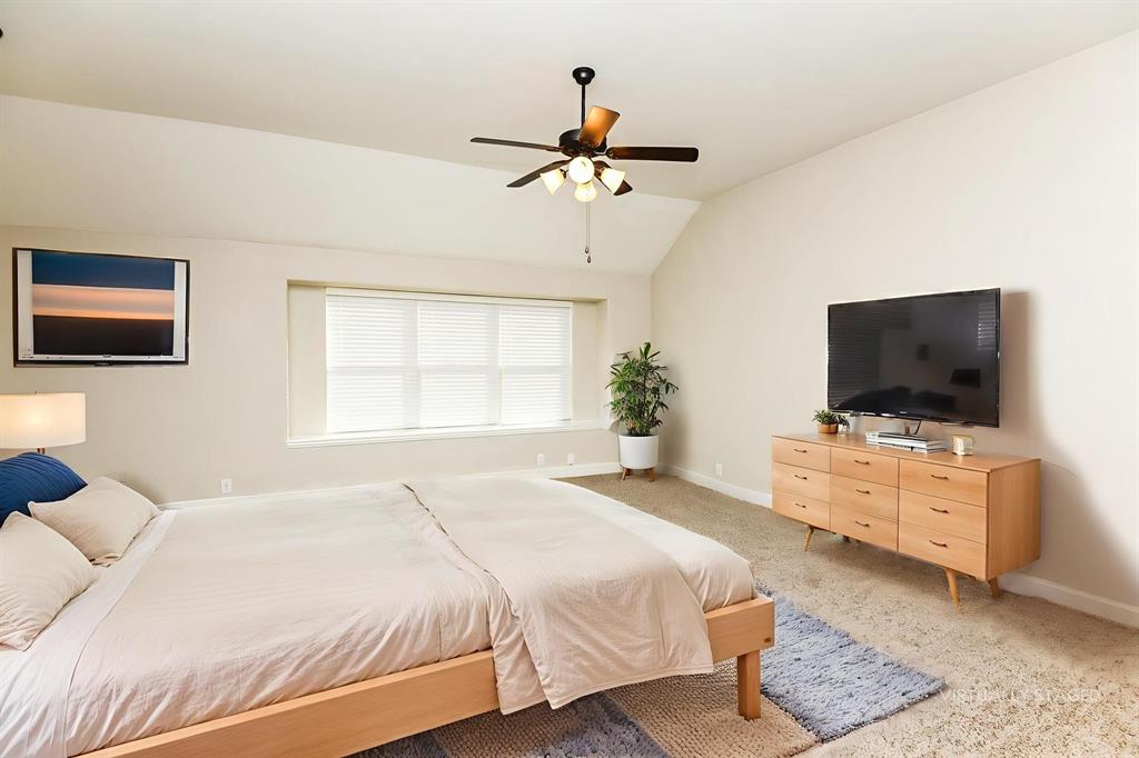 826 Graham Drive Burleson, TX 76028 - Photo 15 of 18 a bedroom with a bed and a flat screen tv