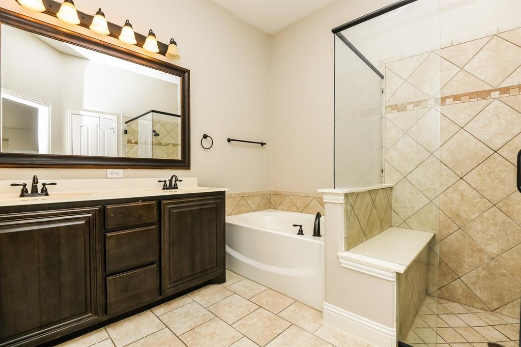 826 Graham Drive Burleson, TX 76028 - Photo 17 of 18 a bathroom with a bathtub sink and mirror