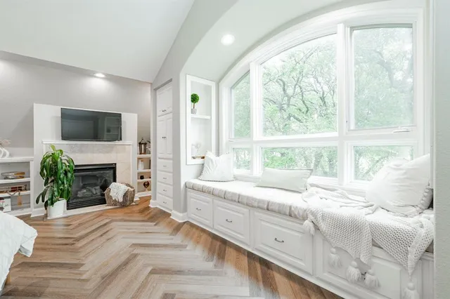 a bedroom with furniture and a large window