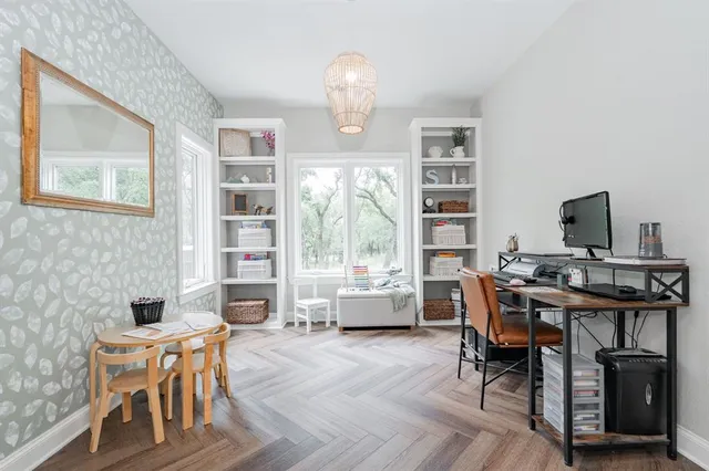 a workspace with furniture window and wooden floor