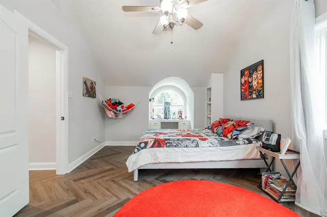 an aerial view of a house with a yard and lake view