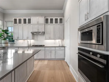 a kitchen with stainless steel appliances a sink a counter space and a window