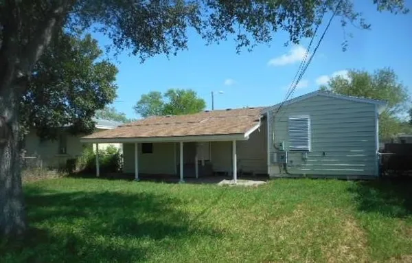 a view of house with backyard and a garden