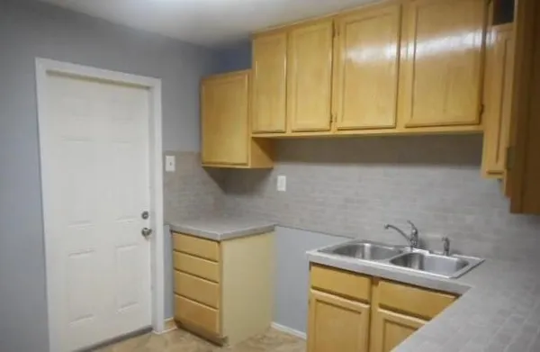 a kitchen with a sink and cabinets