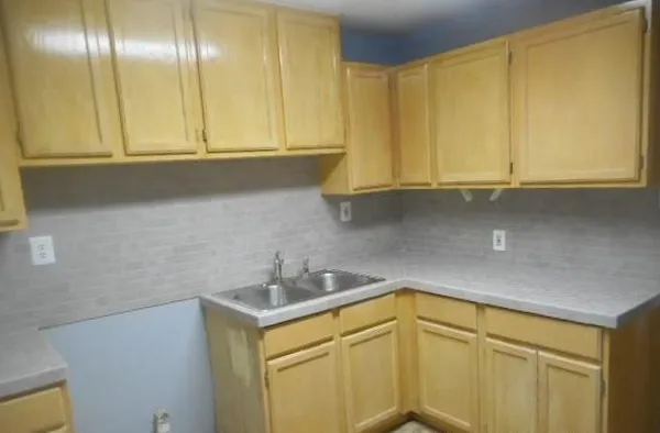 a kitchen with a sink and cabinets