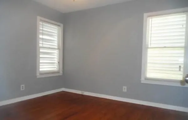 an empty room with a window and closet