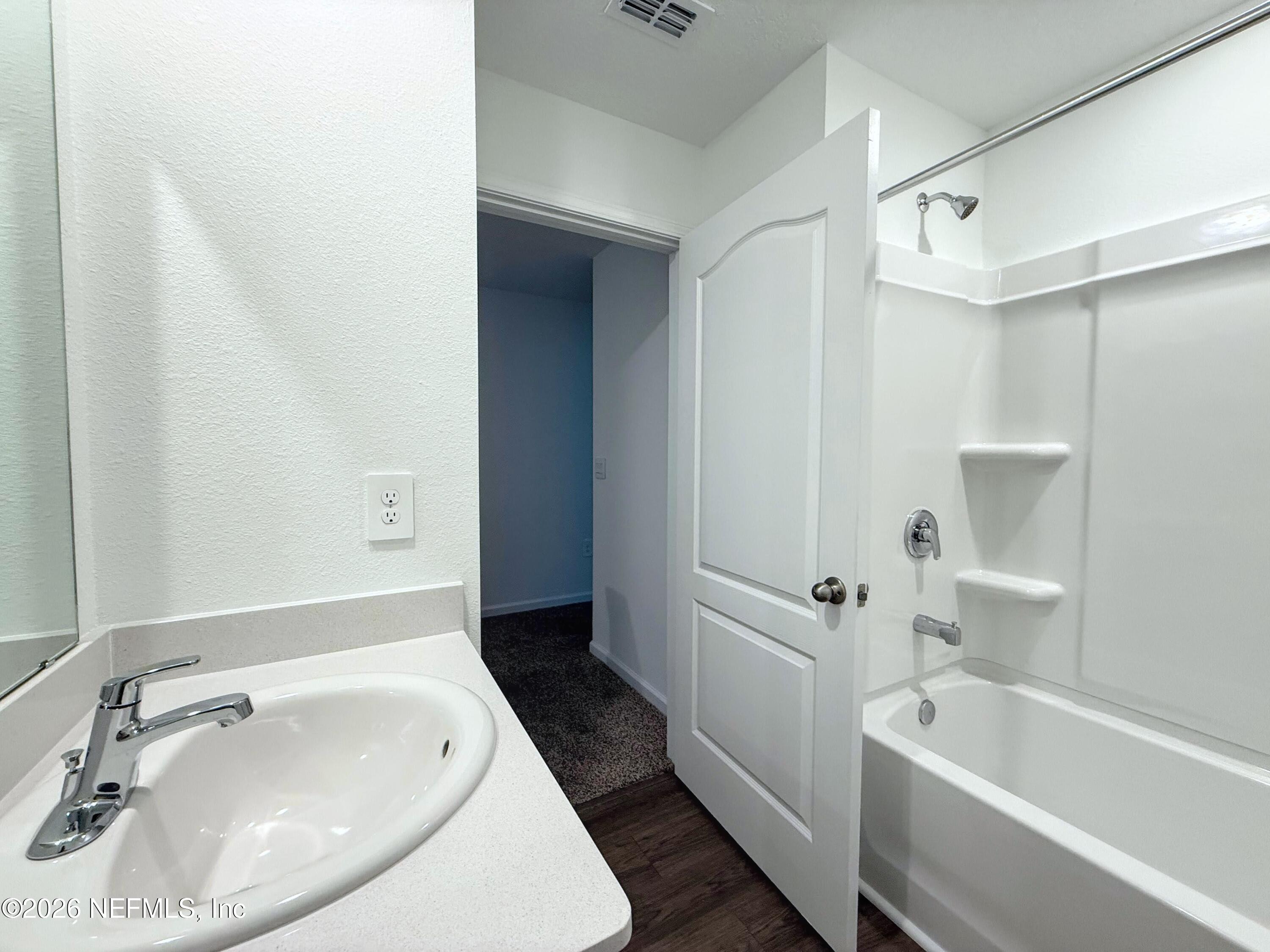 131 Palmetto Rdg Road St. Augustine, FL 32095 - Photo 16 of 22 a bathroom with a tub a sink and a large mirror