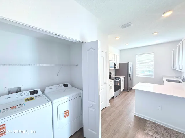 a view of storage and utility room with washer and dryer