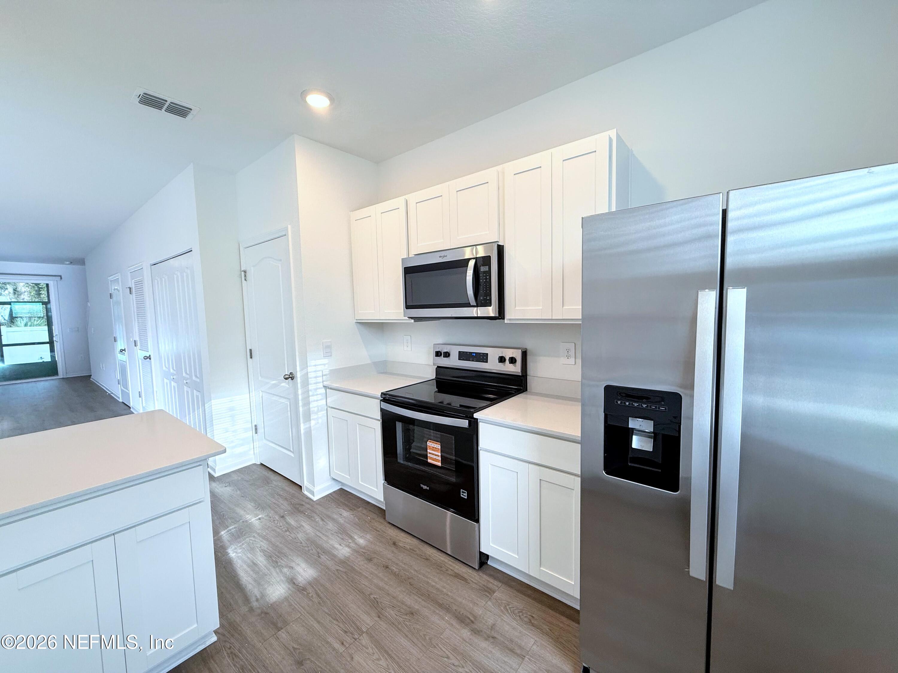 131 Palmetto Rdg Road St. Augustine, FL 32095 - Photo 6 of 20 a kitchen with a refrigerator stove and microwave