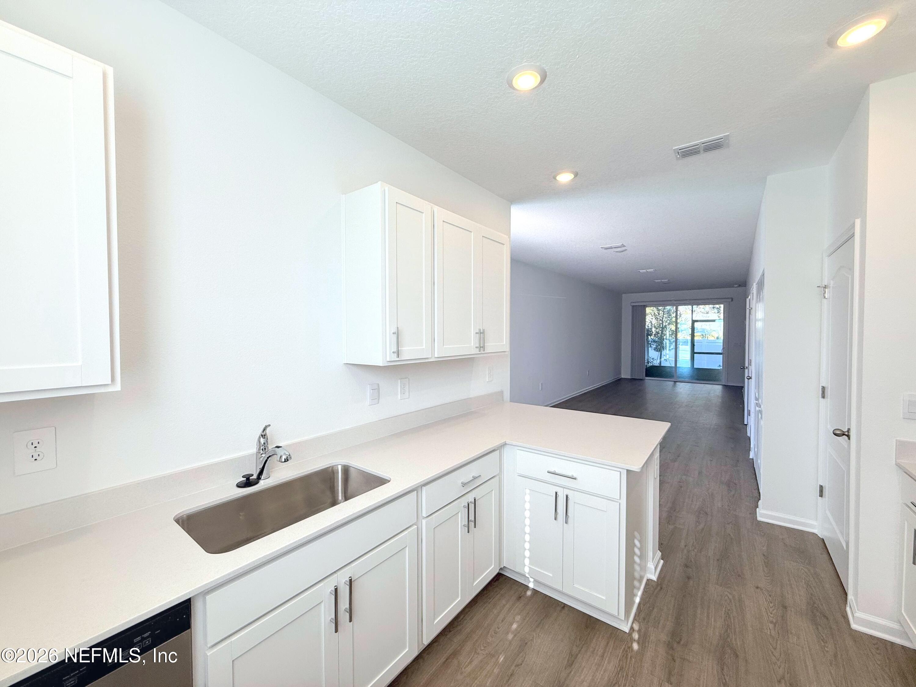 131 Palmetto Rdg Road St. Augustine, FL 32095 - Photo 7 of 22 a kitchen with a sink cabinets and wooden floor